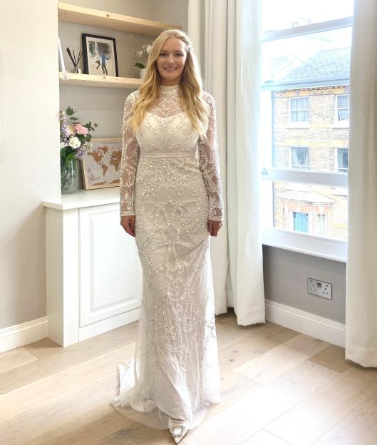 Woman in white dress with bow back detail.