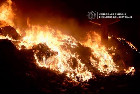Fire raging through a pile of debris.