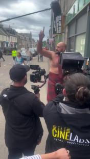 Tyson Fury in a kilt filming a scene.