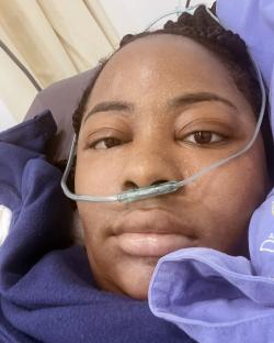 Woman in hospital bed after Brazilian butt lift surgery.