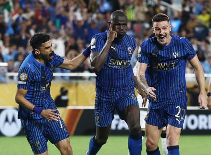 Al Hilal soccer players celebrating a goal.