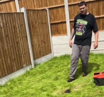 Man standing on a new lawn that is mostly bare dirt.