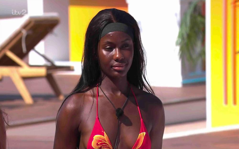 A dark-haired woman in a red bikini top.