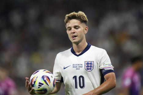 James McAtee of England's U21 team holds a soccer ball.