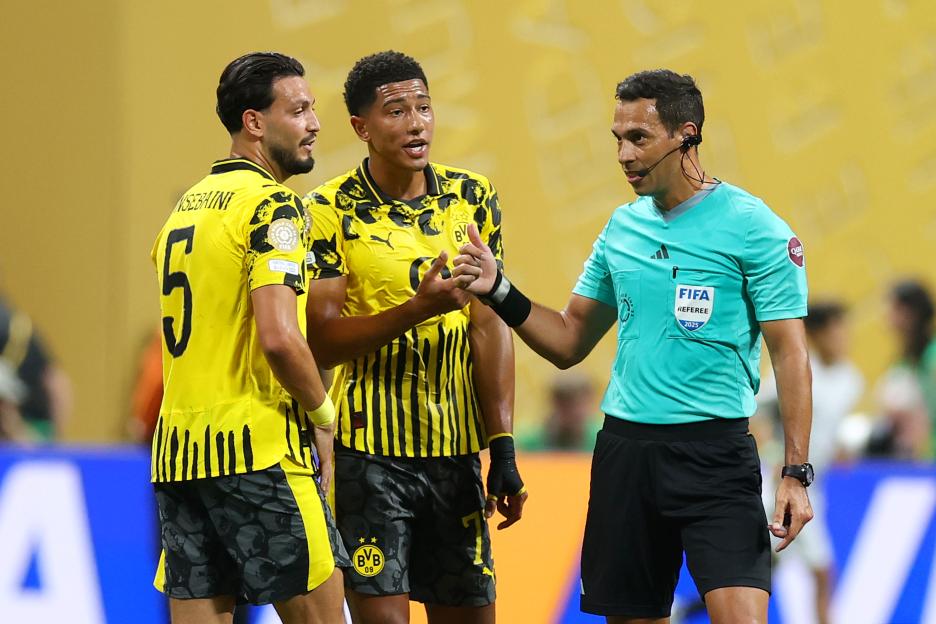 ATLANTA, GEORGIA - JULY 01: Referee Facundo Tello speaks to Jobe Bellingham #77 of Borussia Dortmund after being issused a yellow card during the FIFA Club World Cup 2025 round of 16 match between Borussia Dortmund and CF Monterrey at Mercedes-Benz Stadium on July 01, 2025 in Atlanta, Georgia. (Photo by Carl Recine - FIFA/FIFA via Getty Images)
