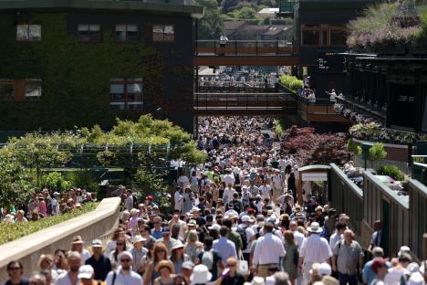 Crowds of people walking around Wimbledon.
