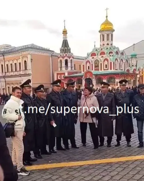 Group of people in uniform standing in front of a church.