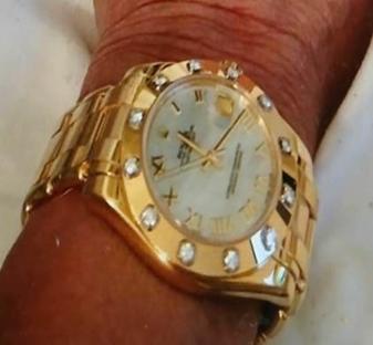 Diamond-encrusted Rolex watch.