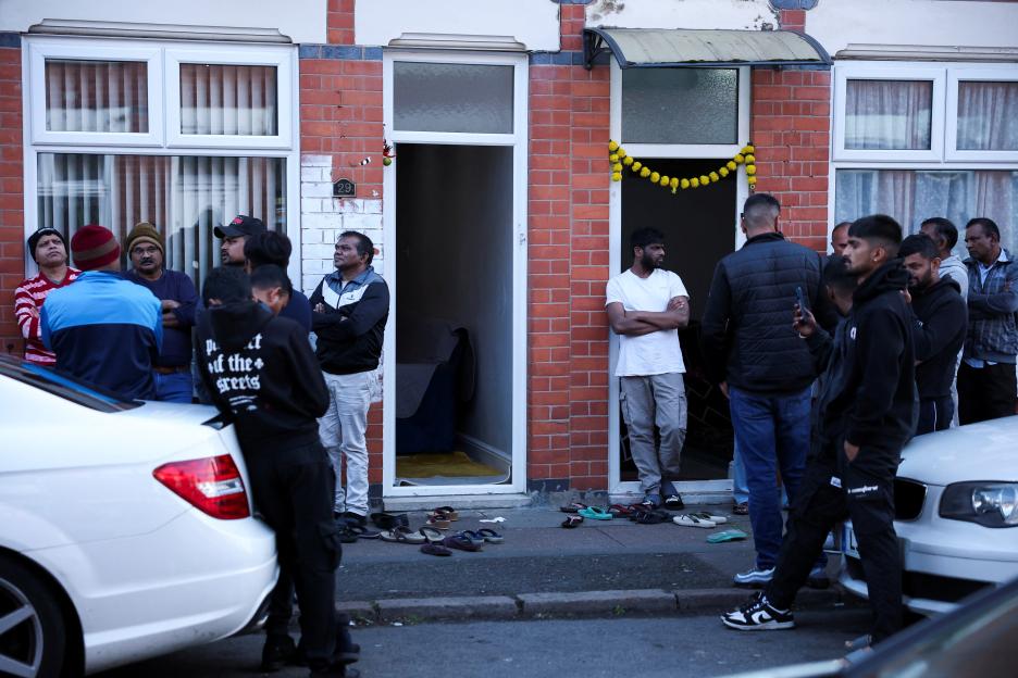 Community members outside the home of an Air India plane crash survivor.