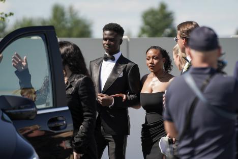 Bukayo Saka and his girlfriend Tolami Benson leaving a wedding.