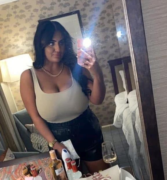 Woman taking a selfie in a mirror.