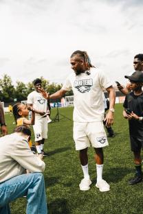 Alex Iwobi interacting with children at a soccer event.