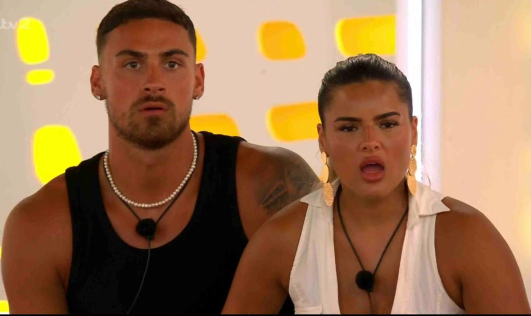 Screenshot of Ben and Andrada reacting to a text message on Love Island.