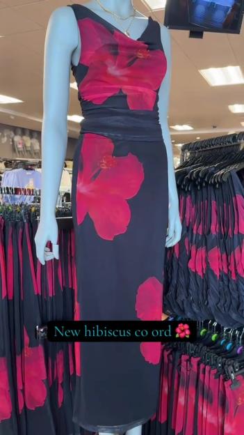 Mannequin displaying a black hibiscus print midi dress and matching top.