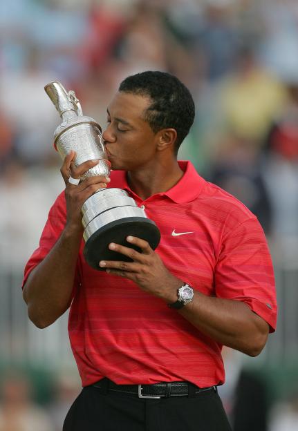Tiger Woods kissing the Claret Jug after winning a golf tournament.