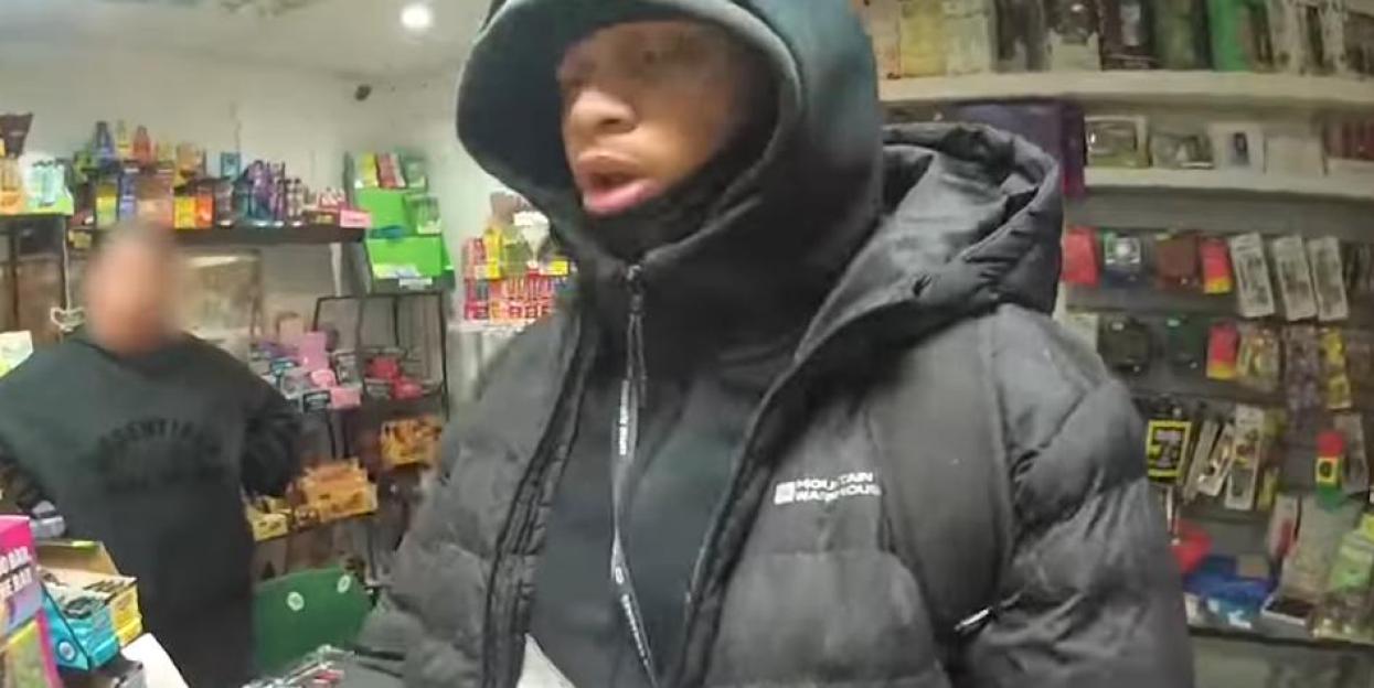 Suspect in a black puffer jacket in a store.