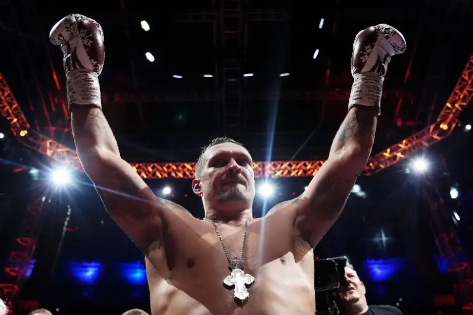 Oleksandr Usyk celebrates a boxing victory.