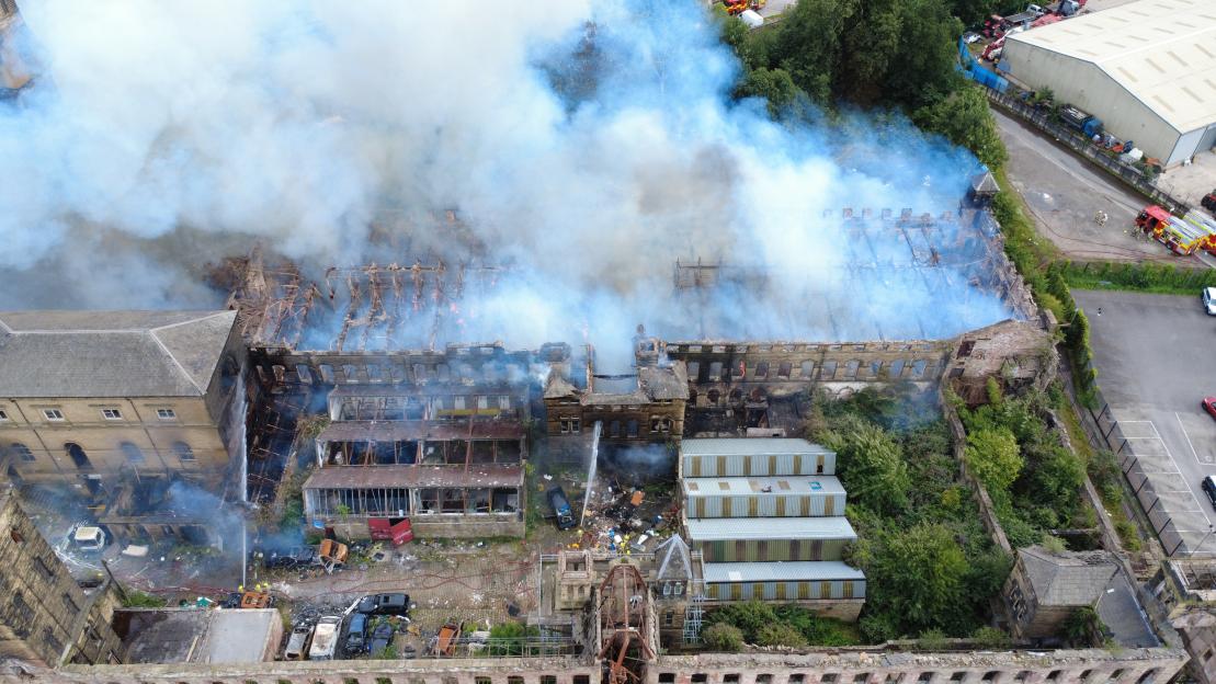Aerial view of firefighters extinguishing a large fire at Dalton Mills.