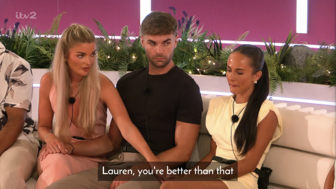 Screenshot of three people sitting on a couch; one man and two women. The caption reads,
