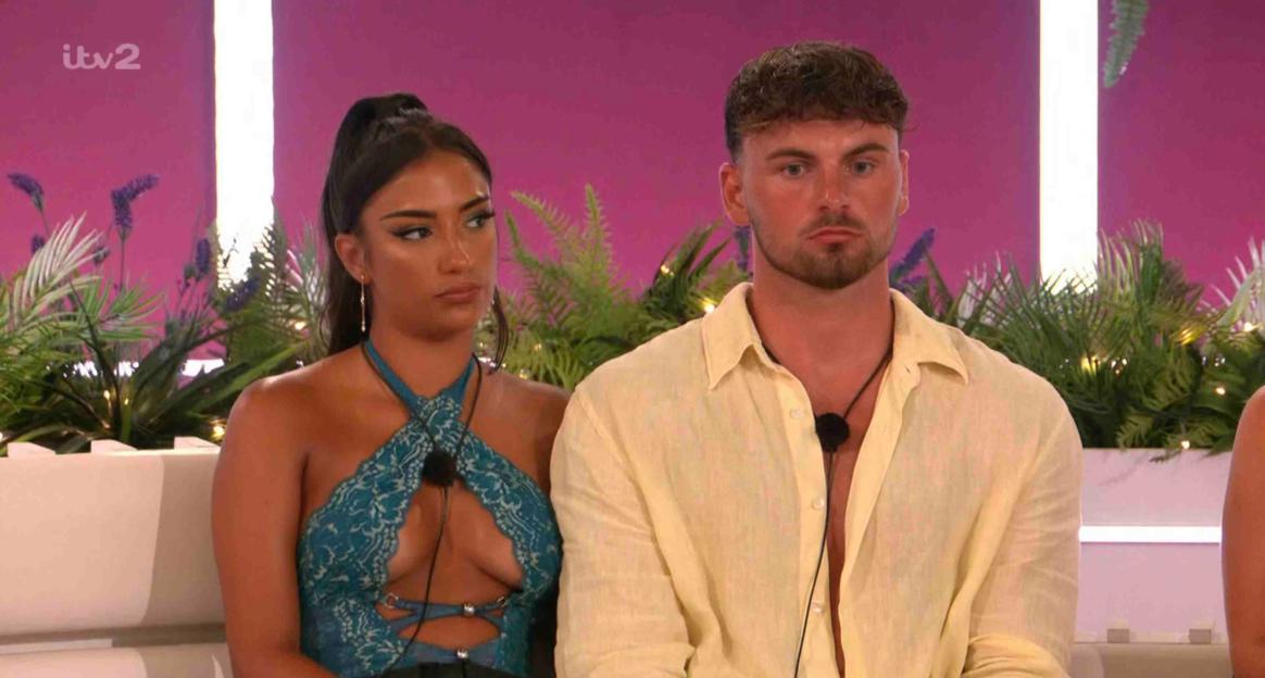Screenshot of two Love Island contestants sitting together.