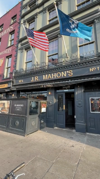 J.R. Mahon's pub exterior with American and Irish flags.