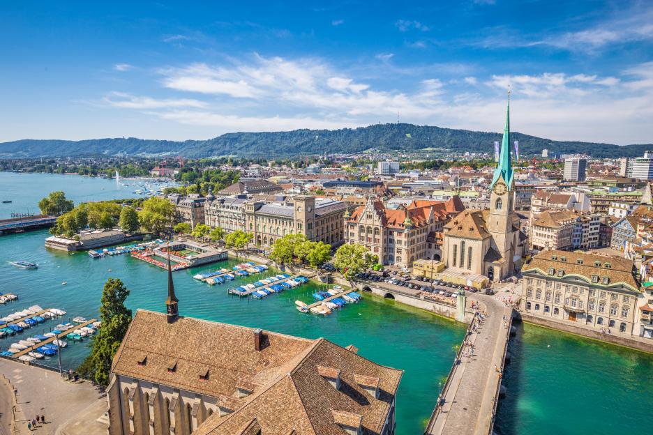 Aerial view of Zurich, Switzerland, featuring the Fraumunster Church and Limmat River.