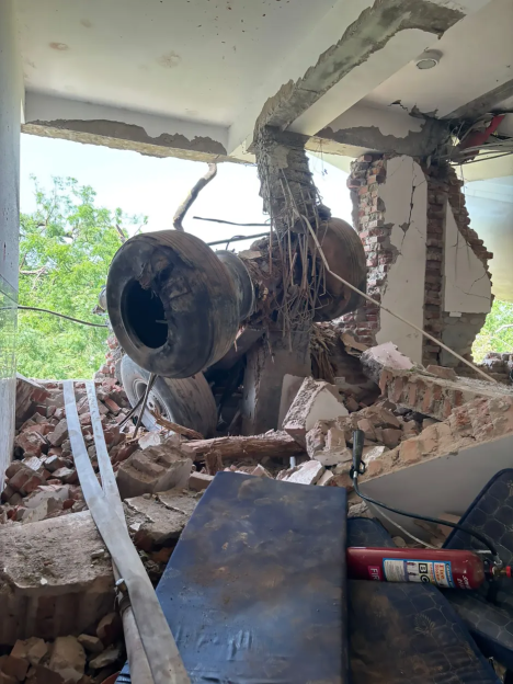 Airplane wreckage inside a damaged building.