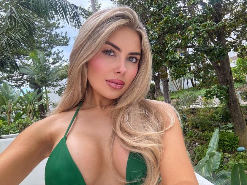 Woman in green bikini top, looking at the camera.