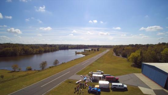 Aerial view of Sugar Valley Airport runway, lake, and surrounding area.