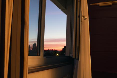 Open window with sunset in the background