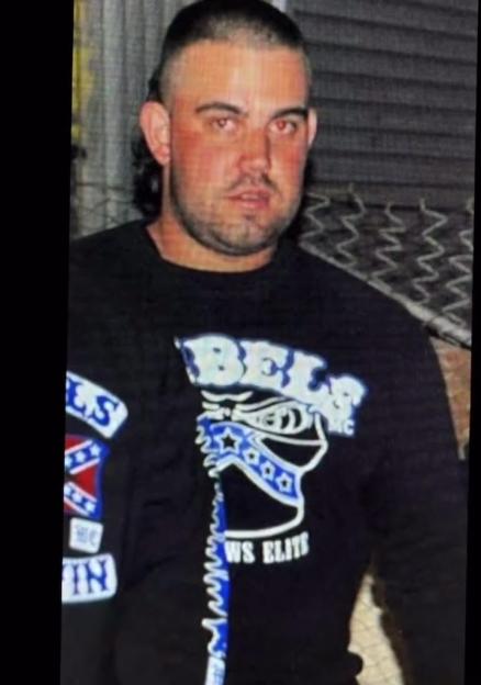 Photo of a man wearing a black long-sleeve shirt with a Rebel Motorcycle Club logo.