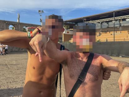 Two young men posing at a music festival.