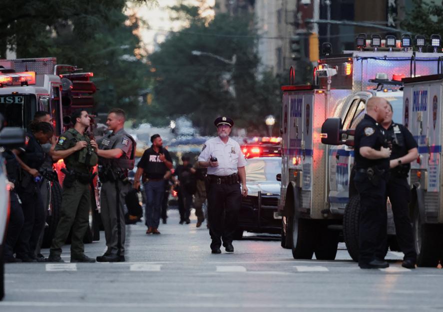 Police officers gather at an active shooter scene in Manhattan.
