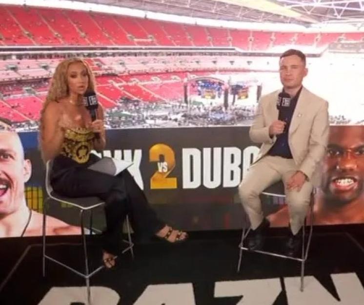 Two DAZN hosts interview boxing fighters in front of a stadium backdrop.
