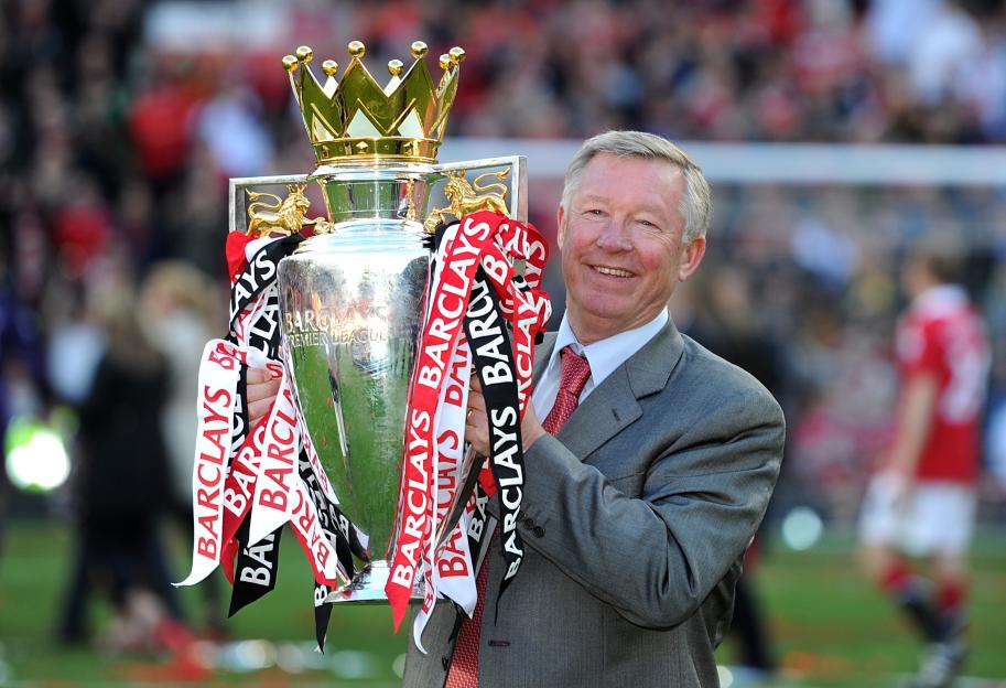 Sir Alex Ferguson holding the Premier League trophy.