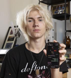 Teenager showing his smartphone with many messages.