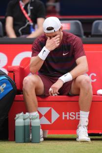 Jack Draper sitting on a bench, looking upset.