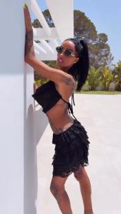 Woman in black lace top and skirt.