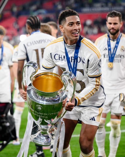 Jude Bellingham holding the UEFA Champions League trophy.