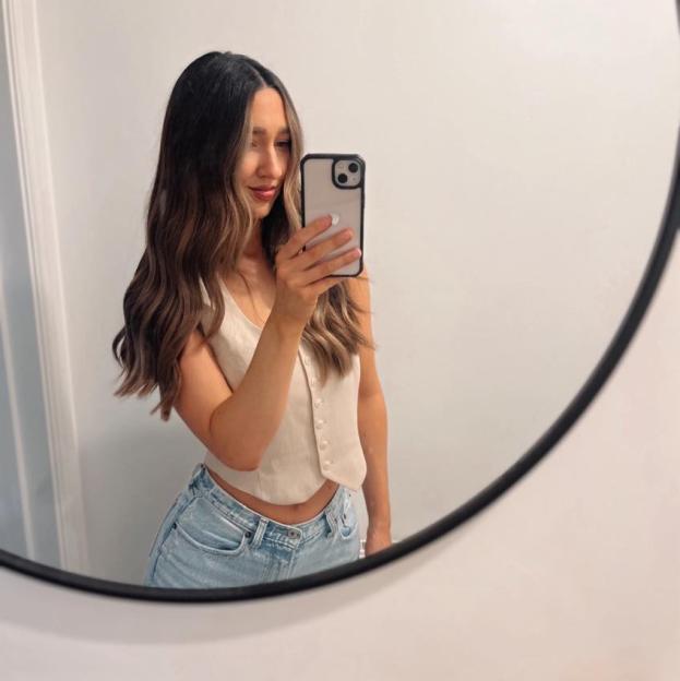 Woman taking a selfie in a mirror.