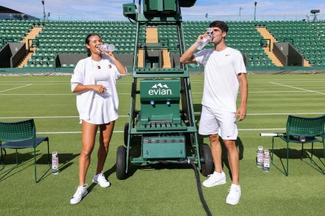 Emma Raducanu and Carlos Alcaraz at a Wimbledon event, drinking evian water.