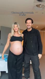 Pregnant woman and man in hospital room, about to meet their son.