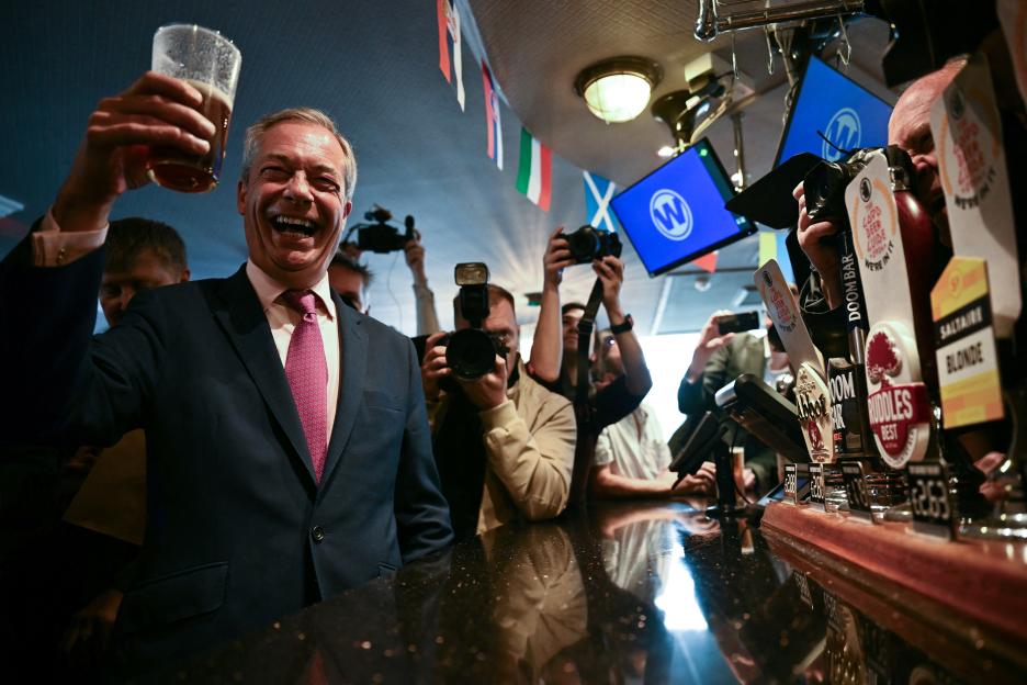 Nigel Farage toasting with a pint of beer at a pub during his election campaign launch.