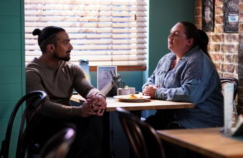 Ravi Gulari and Bernadette Taylor seated at a cafe table.