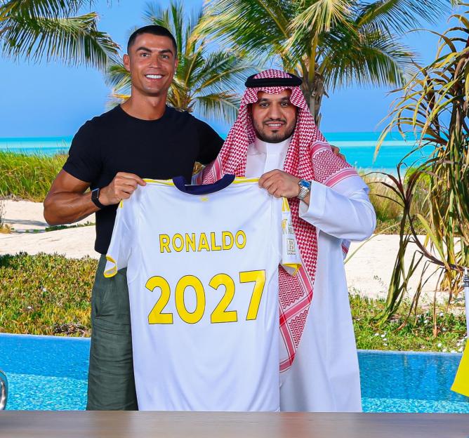 Cristiano Ronaldo and Al Nassr Chairman holding a Ronaldo 2027 jersey.