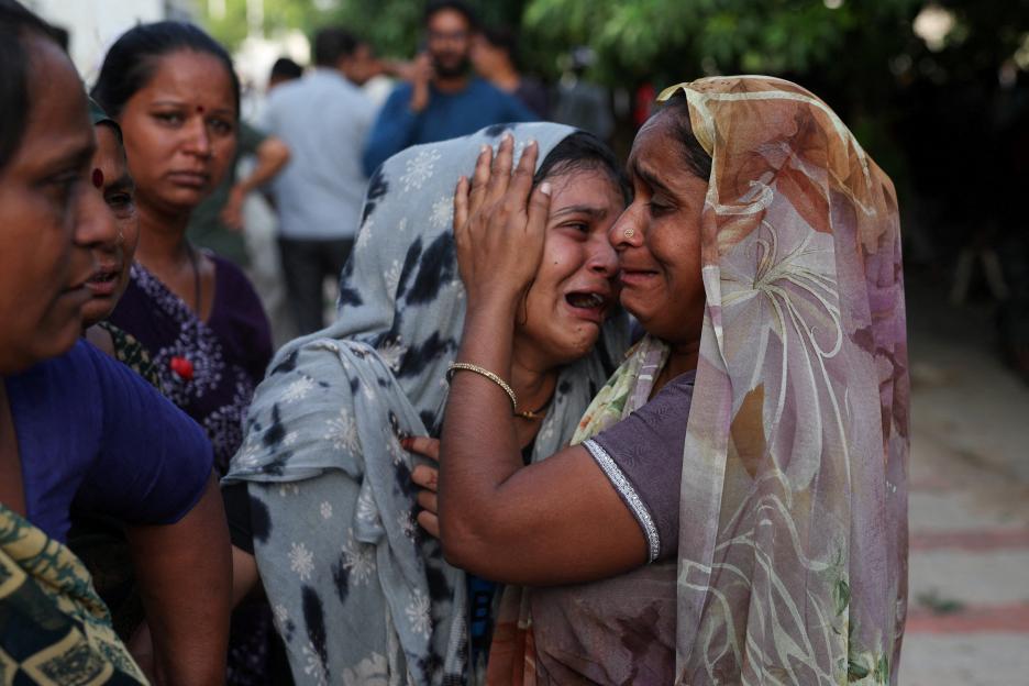A grieving woman comforted by another woman.