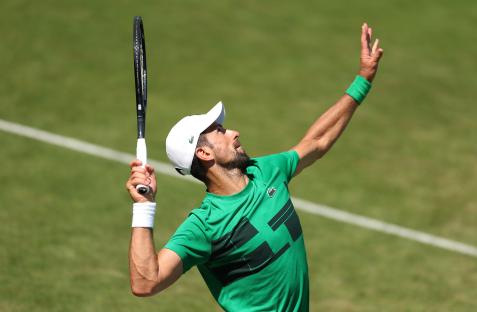 Novak Djokovic serving during a tennis practice.