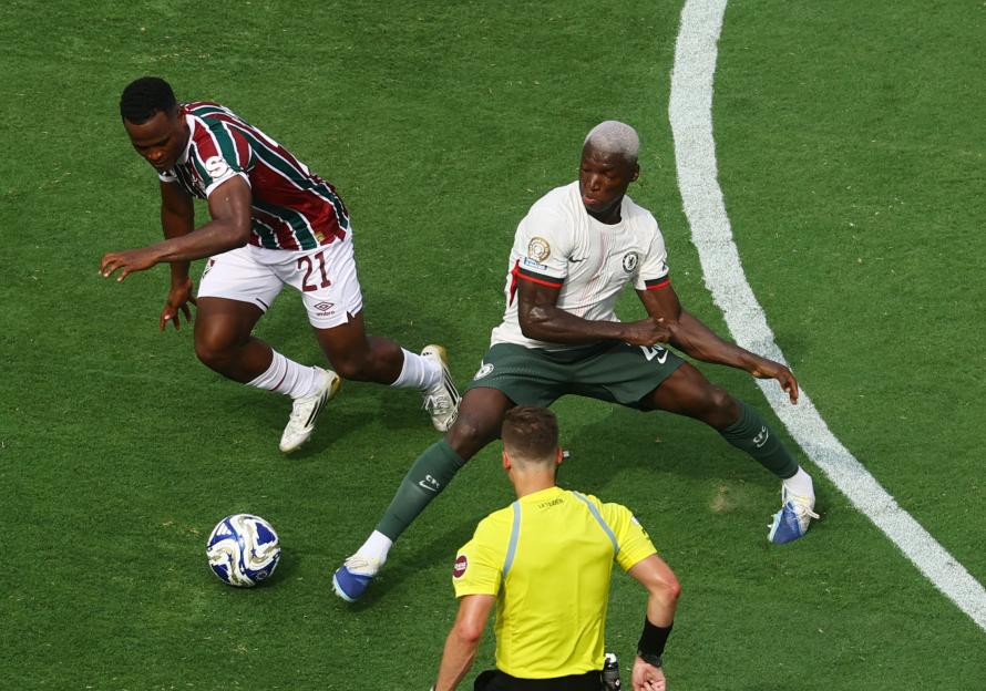 Fluminense's Jhon Arias and Chelsea's Moises Caicedo vying for the ball during a soccer match.