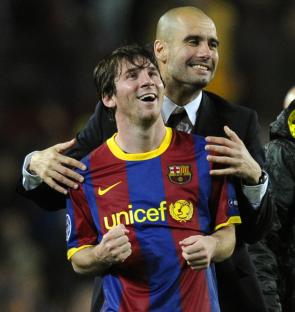 Lionel Messi and Josep Guardiola celebrating.