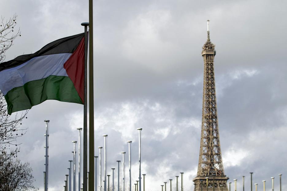 Palestinian flag raised at UNESCO headquarters in Paris, with the Eiffel Tower in the background.